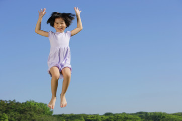 Girl jumping in mid air, smiling