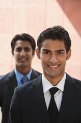 two businessmen smiling (vertical)