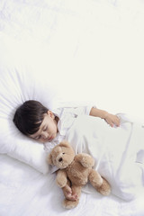 baby boy sleeping with teddy bear