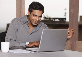 man working at laptop computer