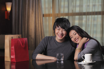Young couple sitting in restaurant together