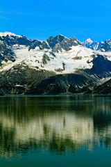 Fototapeta na wymiar Snowcapped Alaskan Mountain reflecting in the ocean