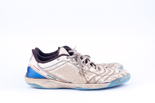 Old blue worn out futsal sports shoes  on white background  isolated 
