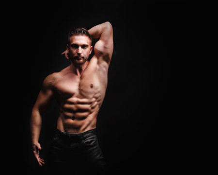 Bodybuilder Posing. Abdominal muscles and triceps.