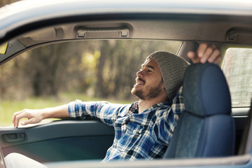 Handsome hipster in the car