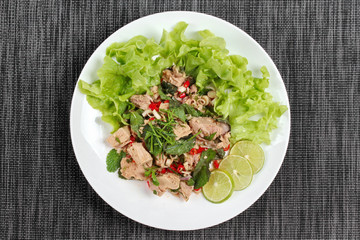 Spicy and sour mixed vegetable salad with canned tuna served .