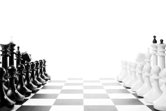 Two chess teams one in front of other on the chessboard. Isolated over white background