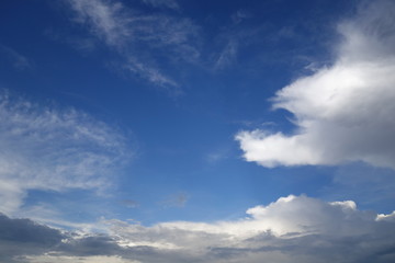 Clouds against clear blue sky background