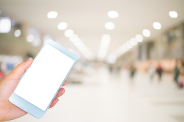hand holding the white smartphone on blurred background