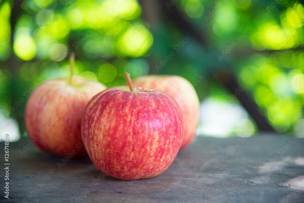 Sticker ripe red apples on wooden background