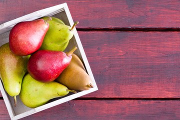 Container with pears over table with copy space