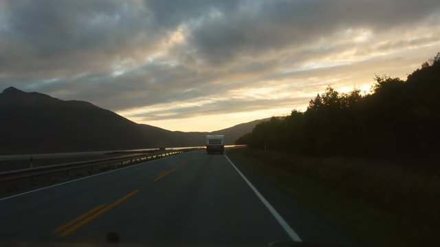 Driving on road E8 toward the city of Tromso, on a nice evening sunset, in north Norway