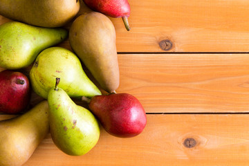Pile of delicious raw pears on wooden surface