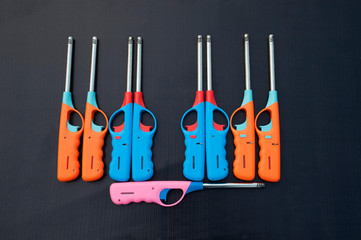 Group of colorful Gas lighter gun for gas-stove on a black background.
