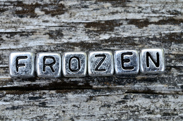 cube word frozen on table