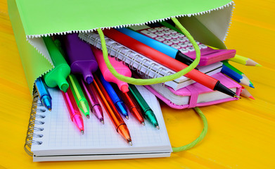 supplies for school in bag on table