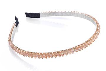 Pale orange head band with beads and semiprecious stones, isolated