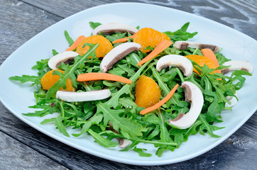 salad with arugula in dish on table