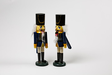 two nutcrackers on with mouth open on a white background