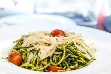Pasta with pesto sauce and nuts on a the table