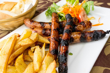 Grilled sausage served with french fries