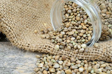 Obraz premium hemp seed in jar flow on table