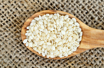 sesame in spoon on burlap