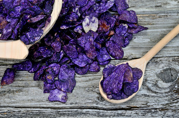 purple potato chips on table with spoon and bowl