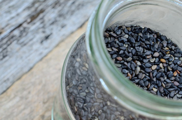 Fototapeta na wymiar black sesame in jar on table
