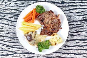 Home made ,Pork steak and mixed vegetables served.