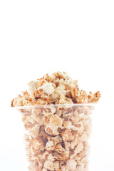 Popcorn in plastic cup on white background.
