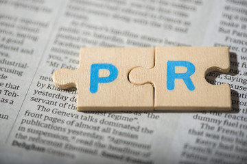 PR letters on newspaper