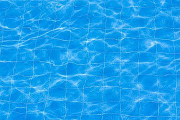 Blue swimming pool rippled water.