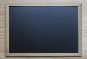 Chalk board hanging on wooden background