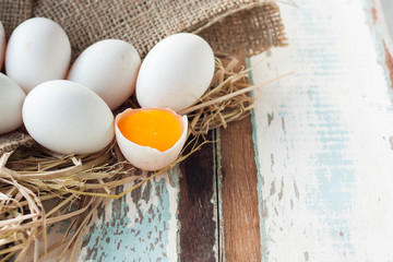 Organic white eggs on vintage wooden background.