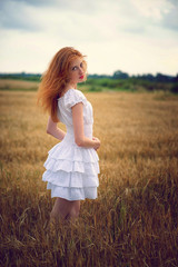 Fototapeta na wymiar Beautiful redhead girl at meadow 