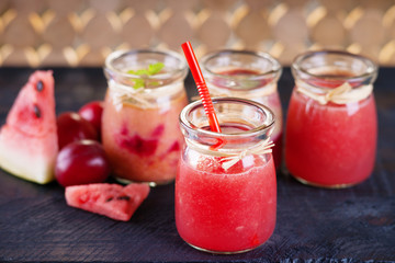 Jars with smoothies and fruits 