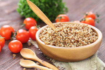 Buckwheat in bowl and fresh vegetables