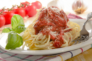 spaghetti with tomato sauce and grated parmesan cheese