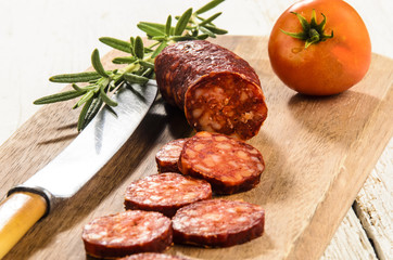 sliced hungarian kolbasz on a wooden board