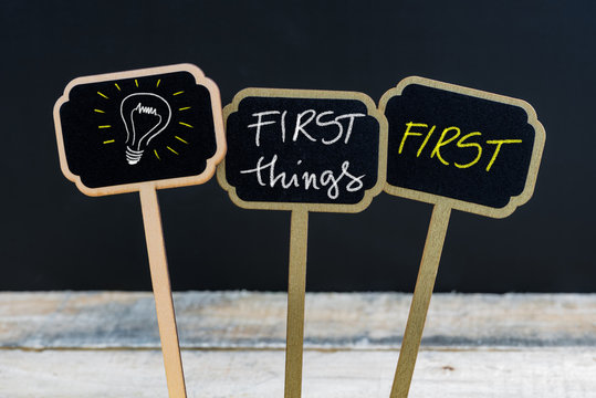 Concept message FIRST THINGS FIRST and light bulb as symbol for idea