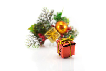 Gift box on a background of branches of the Christmas tree