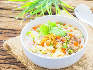 Macaroni soup putting on sack cloth and wooden background