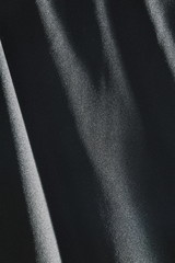 Fototapeta premium black fabric in shadow background and texture