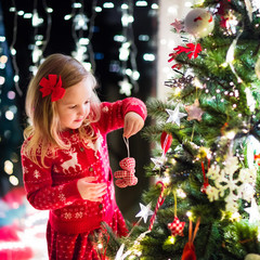 Child decorating Christmas tree