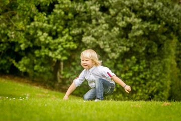 outdoor portrait of young happy smiling boy in park