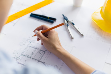 Architect hand drawing blueprints