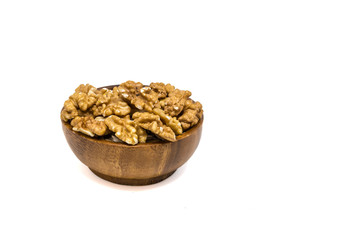 Obraz premium Healthy snack of walnuts, closeup in a natural wooden bowl isola