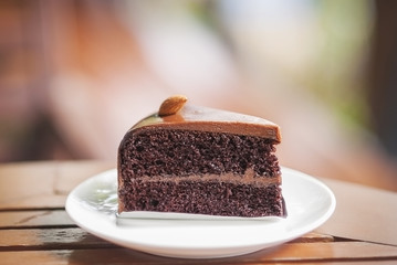 Piece of chocolate cake on wooden table