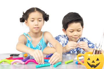 Boy and girl are happily playing clay toy